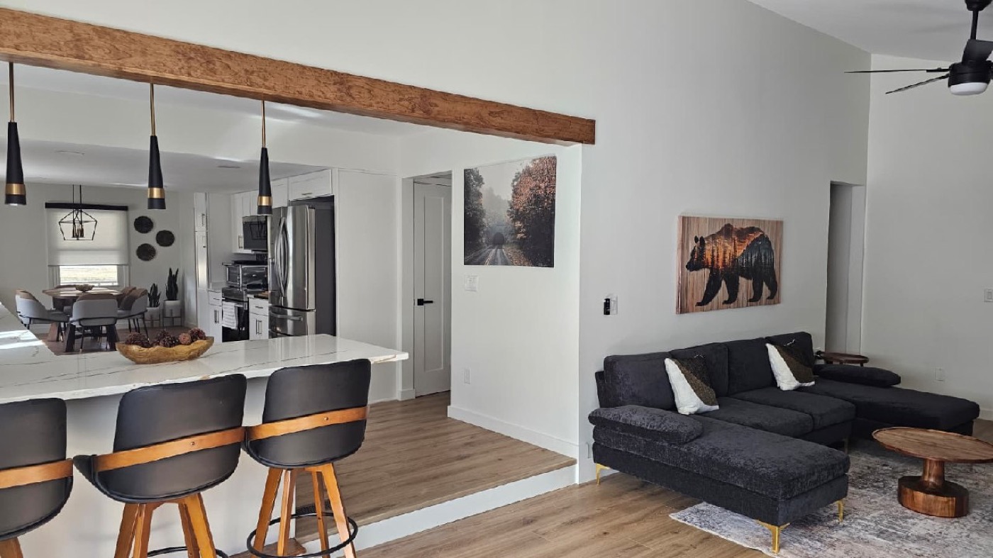 Kitchen island bar with family room and dining area beyond